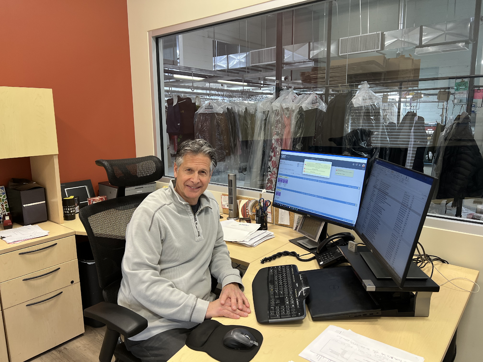 A person sitting at a desk with a computer

Description automatically generated with medium confidence