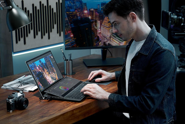 A person sitting at a desk with a computer

Description automatically generated with low confidence