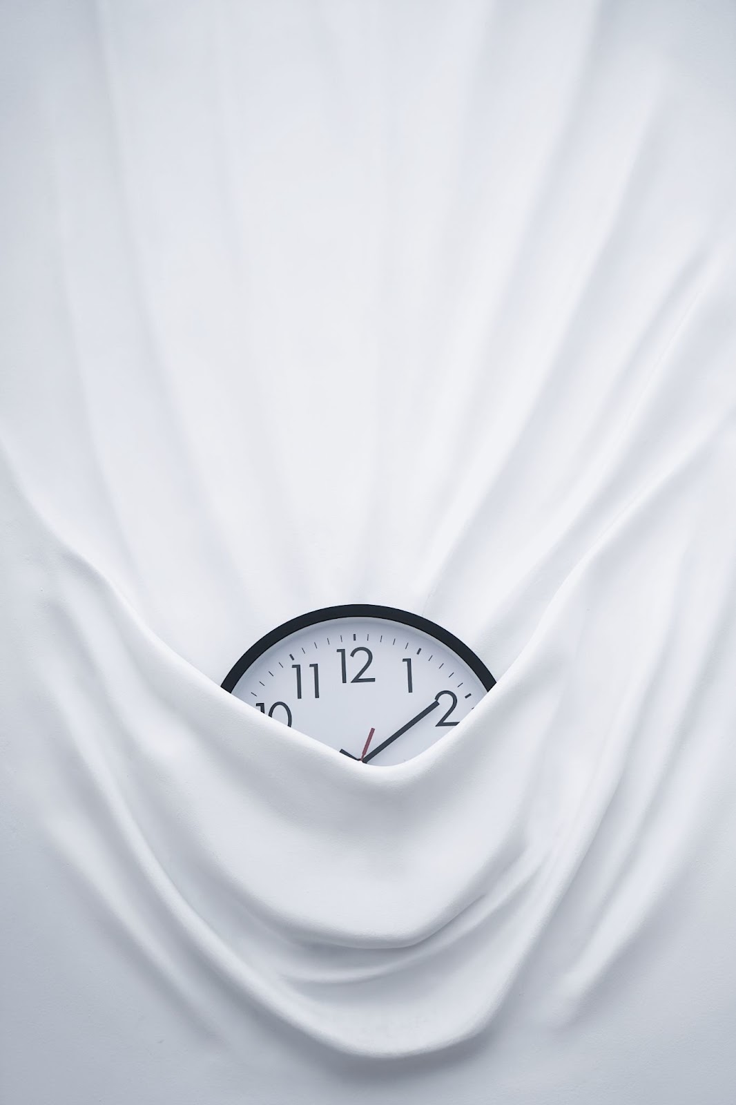 A clock covered partially by a sheet
