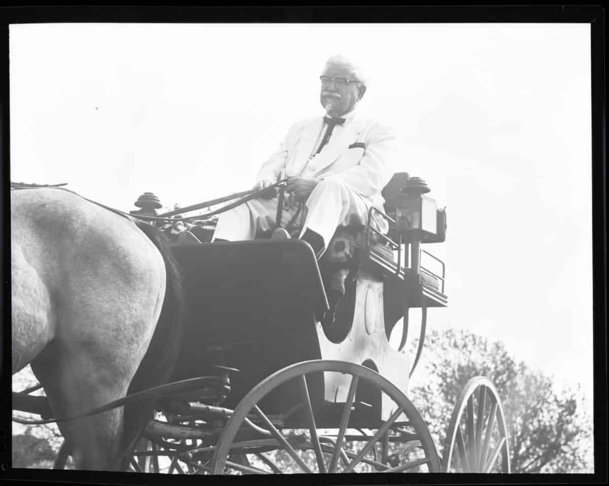 Colonel Sanders rides in a horse and buggy