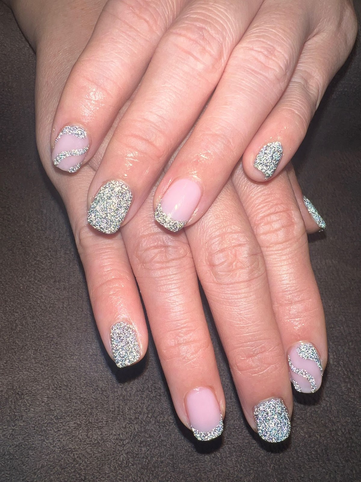 Glittery holiday nails shining in the light