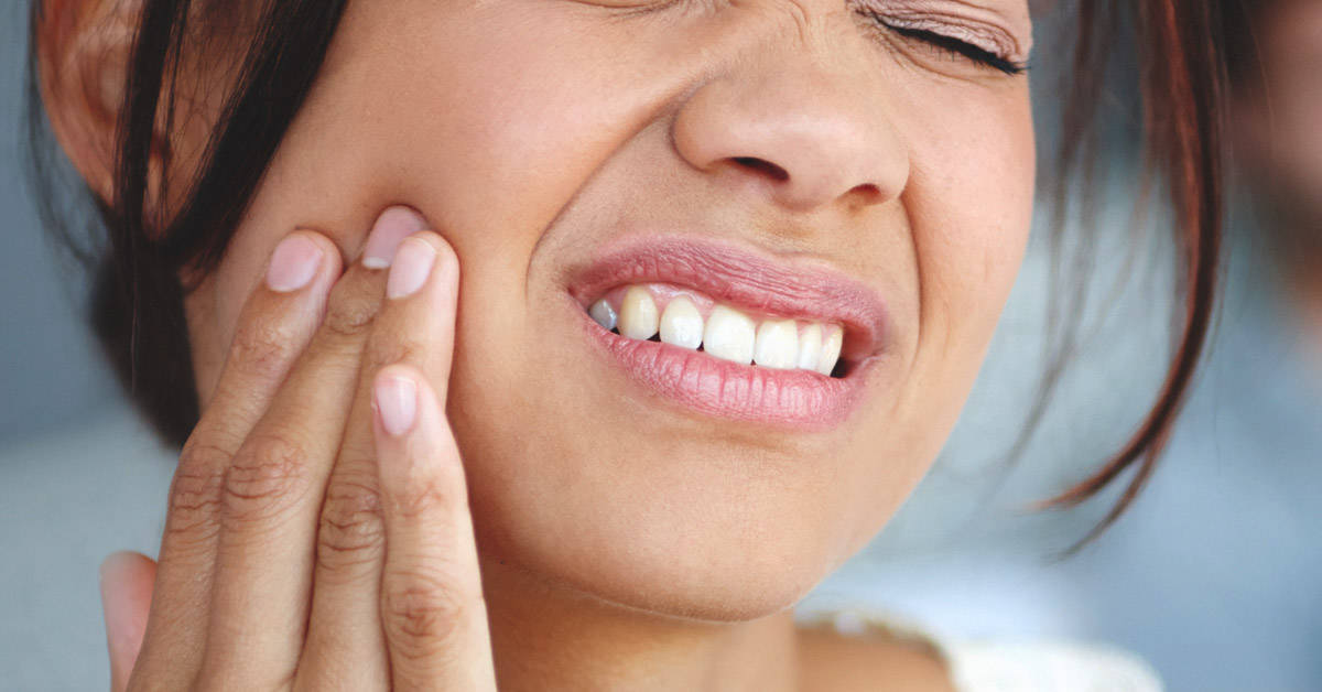 woman having tooth pain in left side of jaw