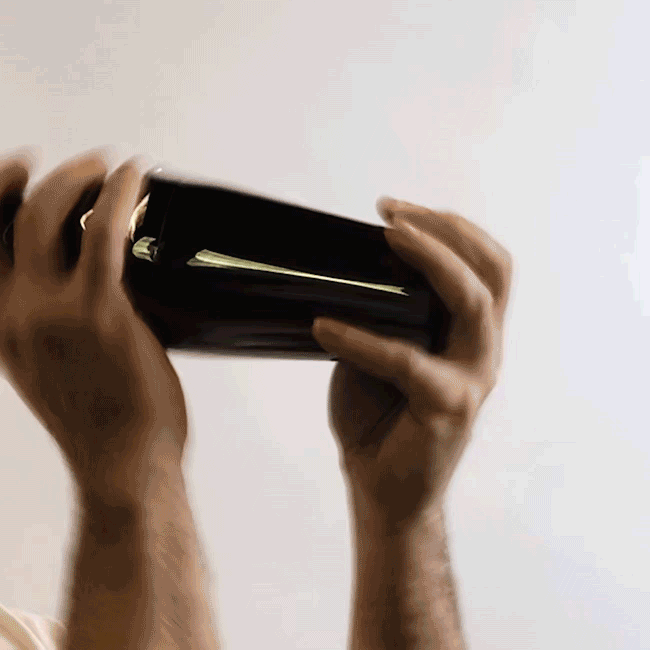 GIF of person shaking a cocktail inside of a cocktail shaker.