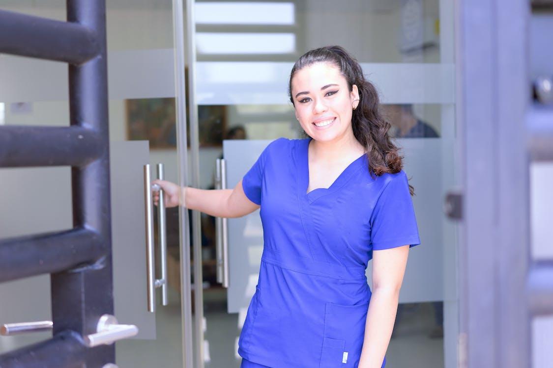 Free Woman in Blue Scrub Suit Smiling Stock Photo