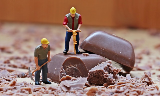 Toy workman breaking up chocolate
