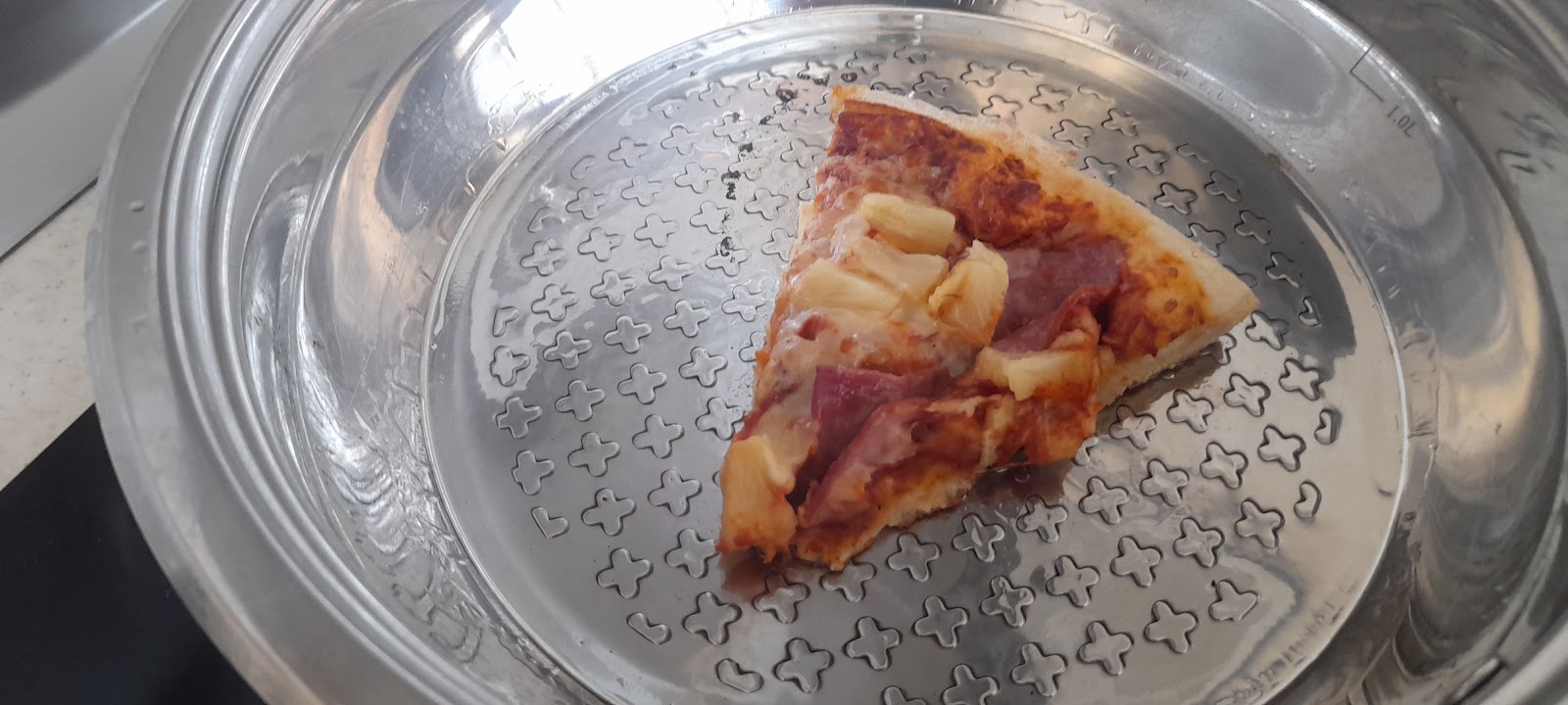 Hawaiian pizza reheated in a pan with a bit of oil.