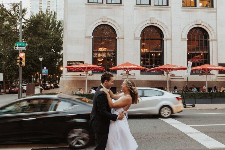 Couple embracing on a city street in Philadelphia on their wedding day
