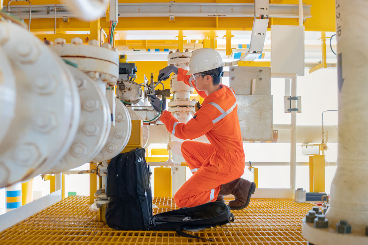 Job safety analysis: technician adjusting a machine