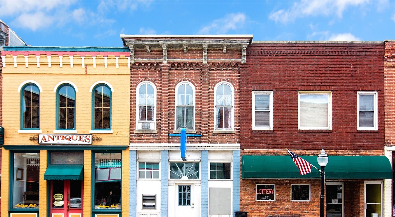 A photo of old brick storefronts in a small town