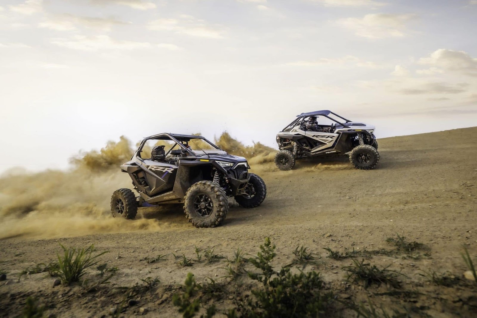 Watch two powerful POLARIS vehicles race up a challenging dirt hill, kicking up clouds of dust and leaving their competitors in the rearview mirror