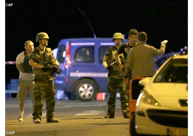 Police officers and soldiers at the scene of a terrorist attack in Nice, France. At least 84 people were killed after a man drove a heavy truck into a crowd of people celebrating Bastille Day. - AP