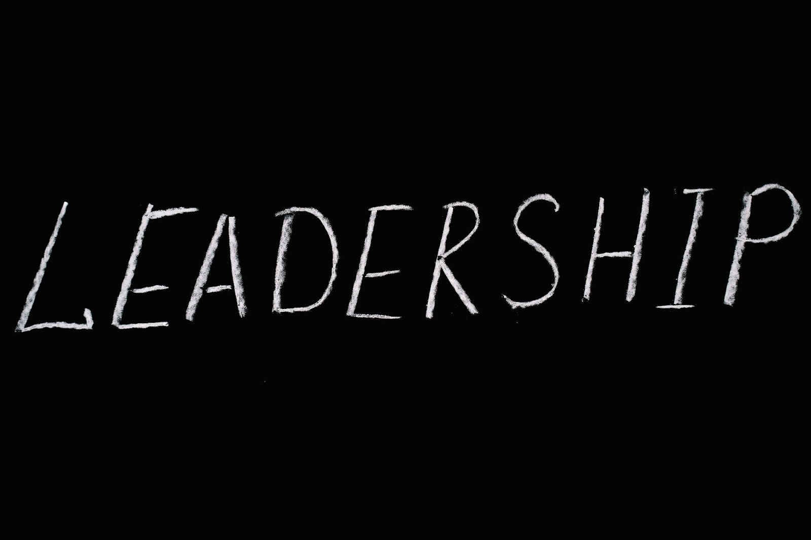 The word leadership over black text