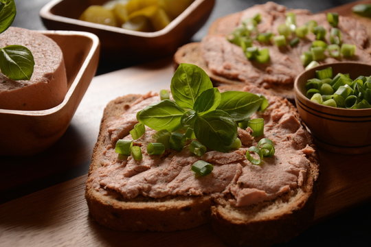 Chicken or goose liver pate sandwiches on a wooden board