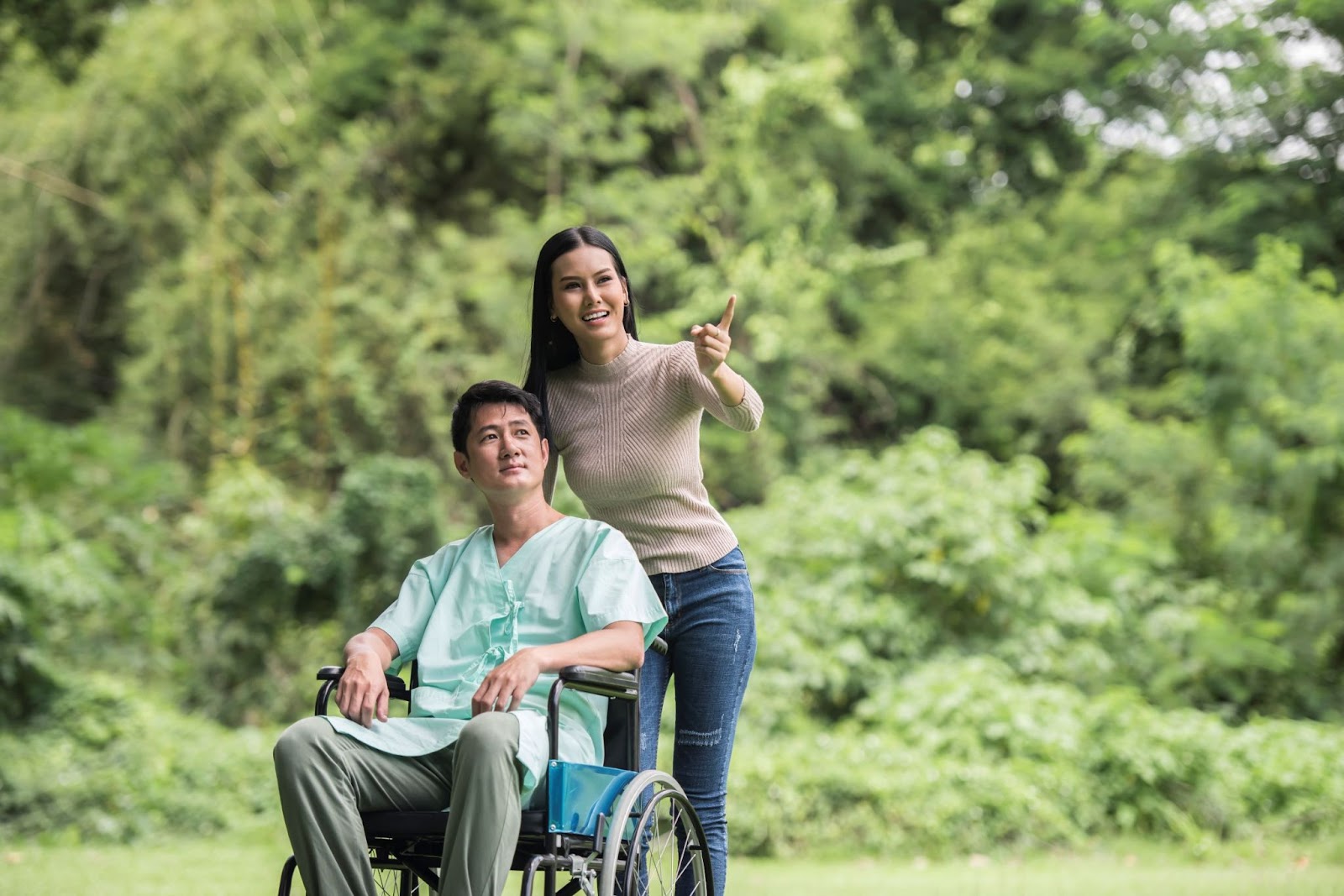 disabled-man-in-wheelchair-with-woman-in-park