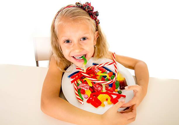 Pretty Happy Child Eating Candy Sweet Sugar Abuse Dangerous Diet Stock  Photo - Download Image Now - iStock