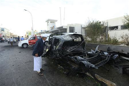 Man peers into vehicle damaged in a car bomb explosion outside a police building in Benghazi, Libya. Violence continues inside the country after the counter-revolution led by US imperialism and NATO. by Pan-African News Wire File Photos
