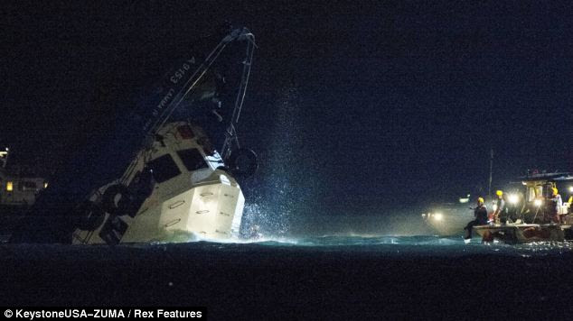 Pitch black: The rescue operation was hampered by low visibility and clutter in and around the vessel