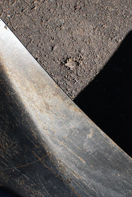 Abstract of a shovel on cement, and its shadow