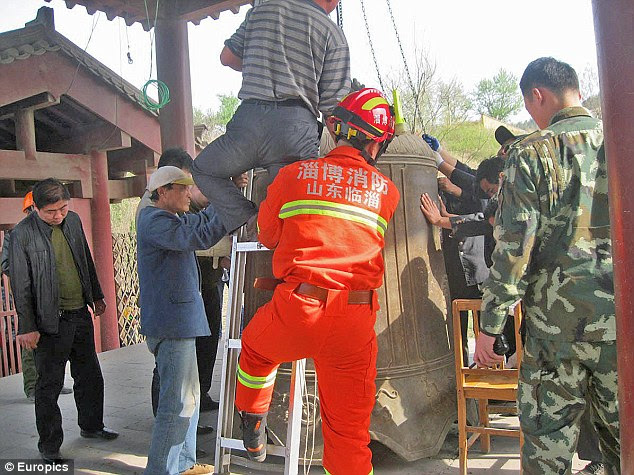 Rescue effort: Staff at the temple in eastern China said the bell should have been treated with more respect