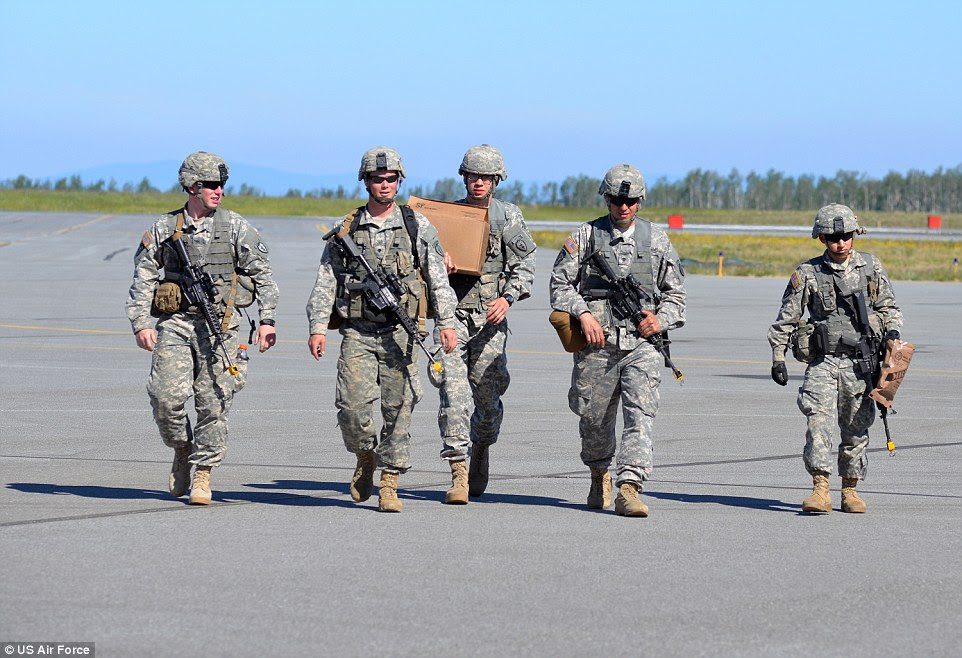 We made it: U.S. Army Soldiers head toward a hanger at Fort Greely after jumping from a U.S. Air Force C-17 Globemaster III aircraft and parachuting into Allen Army Airfield