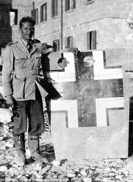 Flight Lieutenant Rhys Lloys of 185 Squadron is pictured with a wing panel from Hauptmann Krahlís Bf 109