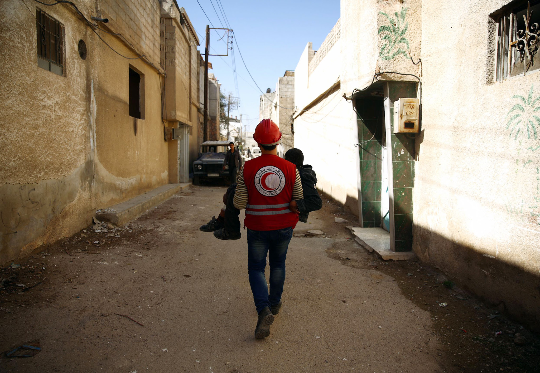 A member of the Syrian Arab Red Crescent...A member of the Syrian Arab Red Crescent carries a wounded boy following an airstrike in the rebel-held city of Douma in Eastern Ghouta, on February 26, 2016. Intense Russian air strikes and regime shelling battered rebel bastions across Syria, the Syrian Observatory for Human Rights said, just hours before a midnight deadline for a landmark ceasefire in the country's five-year civil war. / AFP / Abd DoumanyABD DOUMANY/AFP/Getty Images