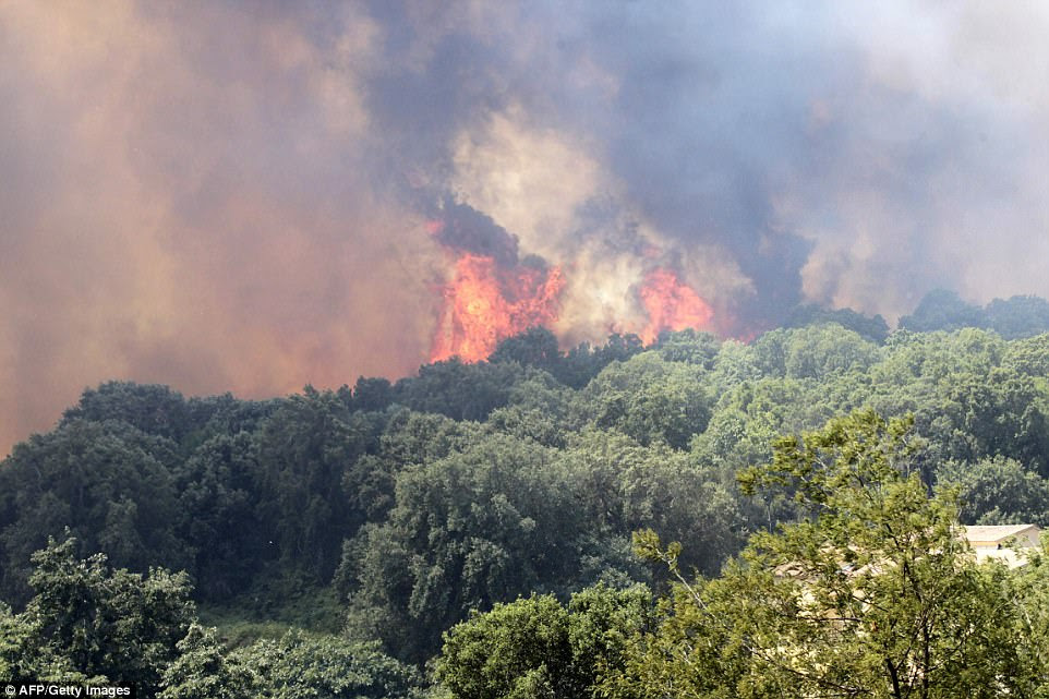 On the island of Corsica, one fire, made worse by strong winds, has spread across 900 hectares of forest and is reportedly threatening to engulf homes
