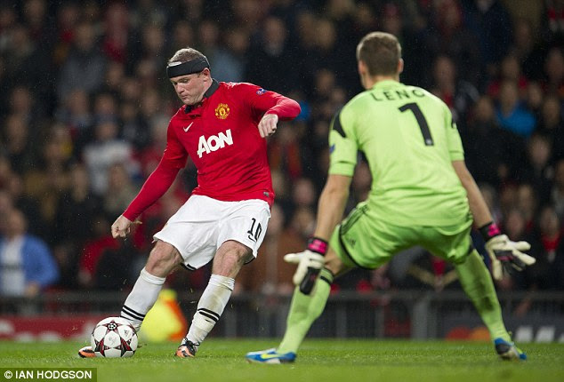 At the double: Rooney clips his second goal of the night - and his 200th for United - over Leno