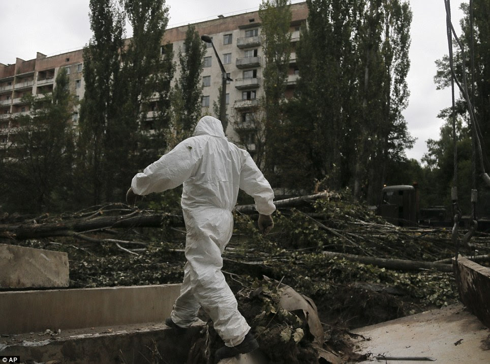 Tough job: A worker patrols Prypyat as dismantling work continues at the scene of the world's worst nuclear accident