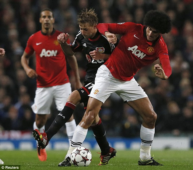 Stuck in: Marouane Fellaini (right) made his full debut for United on the big European stage