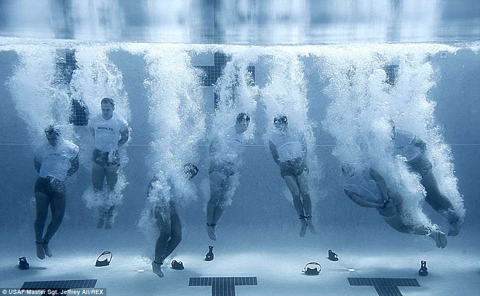 Dive: Members of the Special Tactics Training Squadron enter the pool with their hands and feet bound. The drown proofing exercise teaches students to remain calm in the water during stressful situations, skills that are vital during real-world operations