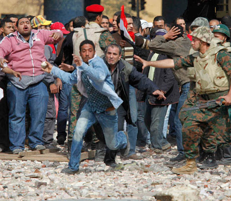 Mubarak supporter tries to get to opposition lines near Tahrir Square in Cairo