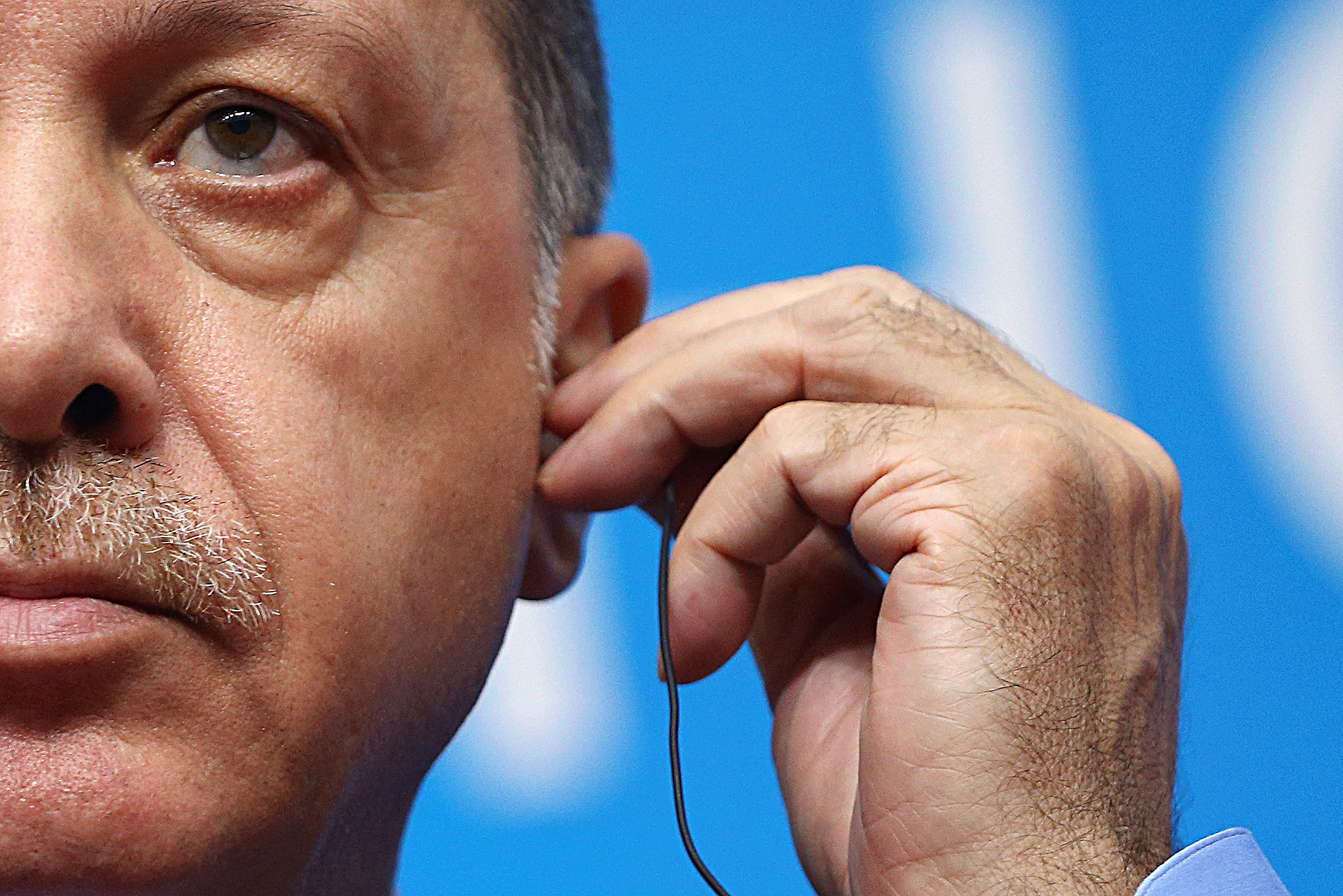 Turkey's President Tayyip Erdogan adjusts earphones during a news conference after the closing of G20 Summit in Hangzhou, Zhejiang Province, China, September 5, 2