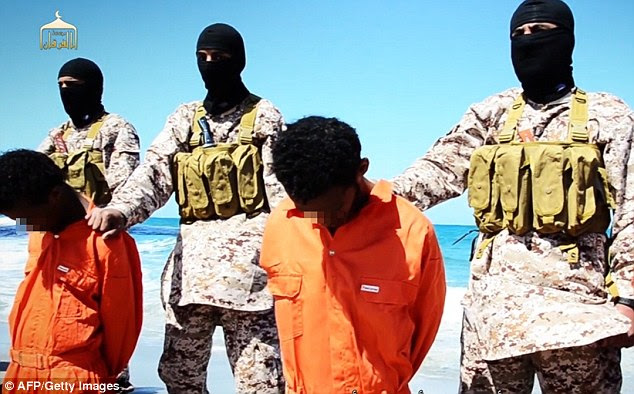 The men are held at the neck and forced to kneel by fighters in combats with balaclavas covering their faces