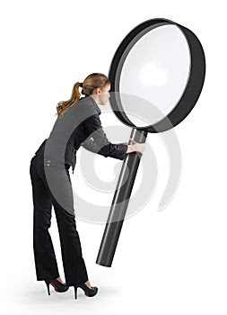 Woman looking through a magnifying glass