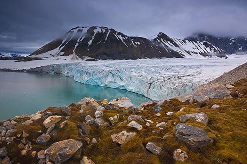 Jenny Ross |A summer storm approaches one of the many spectacular tidewater glaciers on Spitsbergen in Norway’s Svalbard Archipelago. The view is from atop a high lateral moraine left behind by the receding glacier.