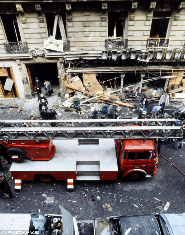Rescuers and policemen are seen on the site where a bombed car exploded in Rue Marbeuf, near Champs Elysées in Paris on April 22, 1982. The attack was attributed to Carlos the Jackal