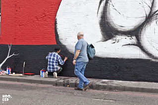 Italian street artist Run paints a new mural on East London's iconic Village Underground Wall. Italian street artist Run paints a new mural on East London's iconic Village Underground Wall.