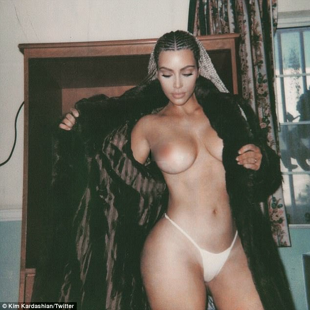 She's not shy! Topless Kim Kardashian holds open a fur coat to expose her breasts as she poses in her panties
