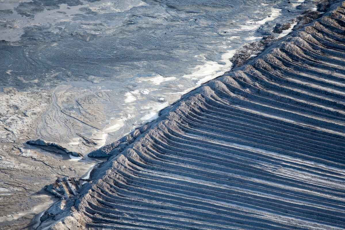 Earthen wall to tailing pond. Suncor mining site, Alberta, Canada.
