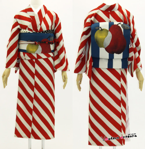 BAM. This is all you need to know about modern graphic kimono.
Flat, bold colors, geometrics, modern rendered design on the obi, black and white, Western primary colors, deep saturation!
This kimono is unstoppable.
Note the awesomely subtle silver line peeking between the red and white stripes—they aren’t graphically precise, but almost hand-drawn. That little touch of imperfection gives this an imperceptible softness and organic feel that perfect computer-aligned stripes would lack. With the halftone screen look of the obi, that subtle imperfection is carried throughout the whole coordination.
Don’t forget the repetition of the small dot-matrix motif in the obiage and obijime.
着物 ボールドストライプ(赤) Mサイズ
Kimono: Bold stripe (red) M size
50,400 yen from Modern Antenna