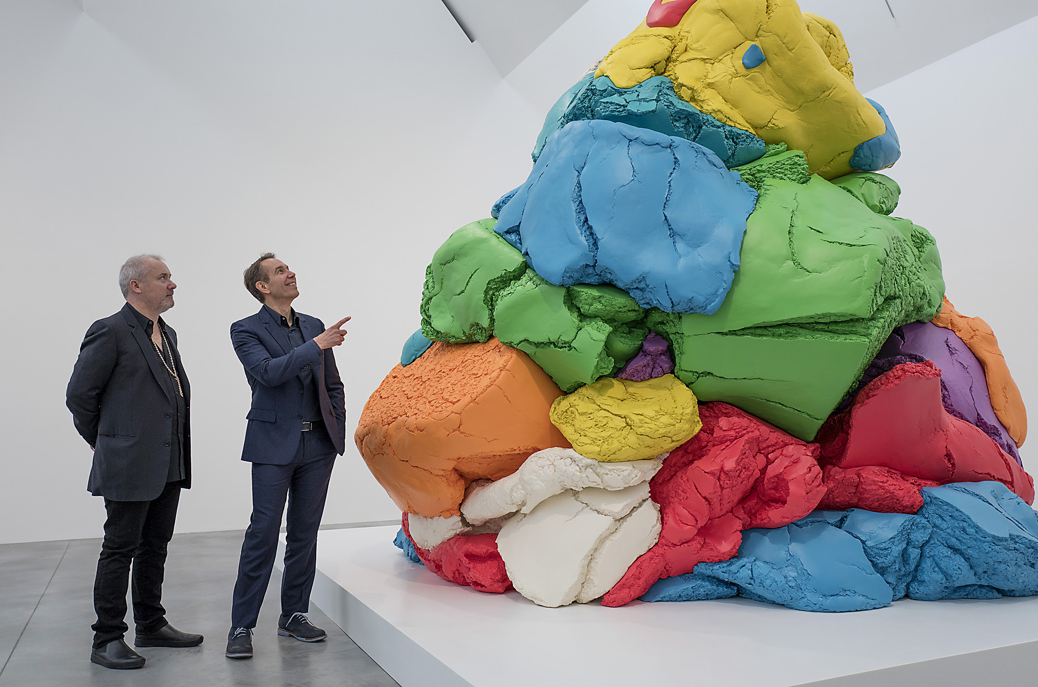 Artists, Jeff Koons and Damien Hirst pose during a photocall to launch the Newport Street Gallery in London with Koon's piece "Play-Doh".