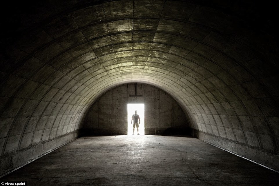 The company's latest offering, the XPoint, is advertised as the largest 'prepper' community on Earth. Pictured is a man looking into a bunker before it is developed