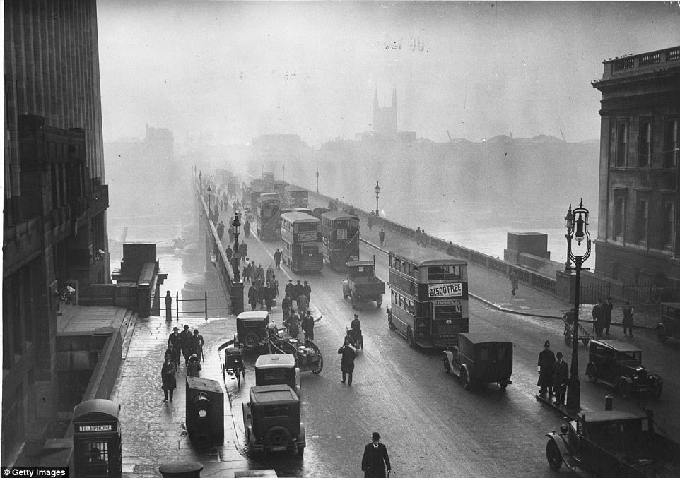 Early morning rush hour traffic crossing London Bridge, central London in January 1933