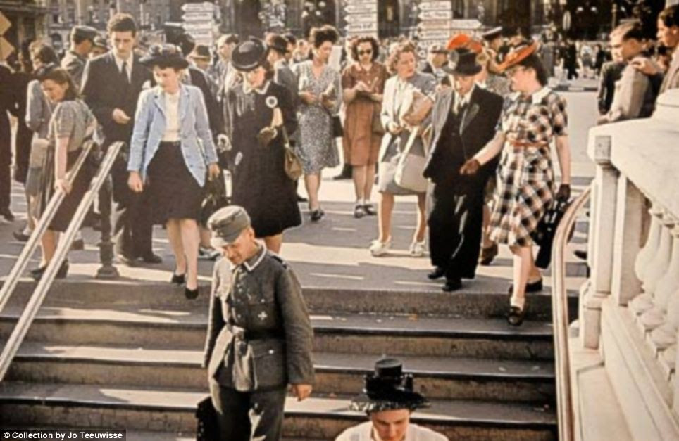 Propaganda: Historians say images such as this one of a Nazi solider (on steps) walking freely with Parisians 