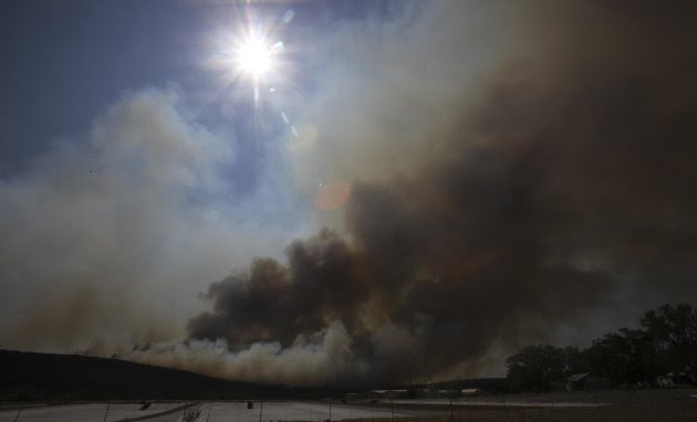 Smoke rises from a wildfire at Possum Kingdom Lake, Texas, Wednesday, Aug. 31, 2011. Texas and Oklahoma are in the grips of a record-setting drought, and a summer of soaring temperatures and little