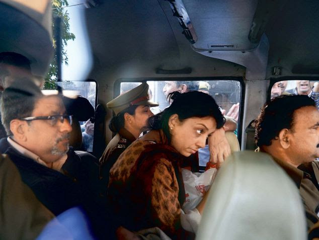 Charged: Rajesh Talwar, right, and his wife Nupur, center, are driven away by Indian police outside a court after their trial yesyterday