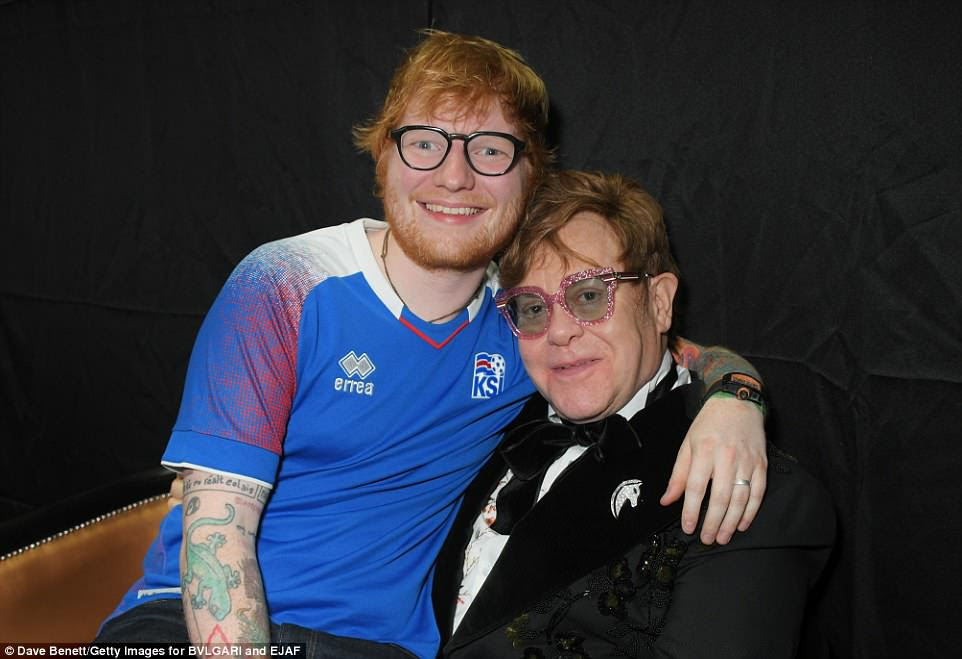 Pals: Ed wrapped his arm around Elton while they caught up backstageÂ