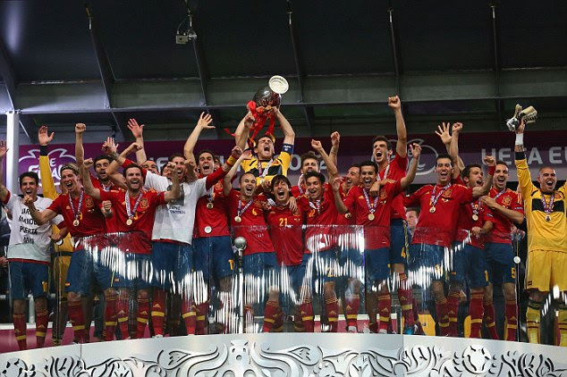 Champions! Casillas holds the trophy aloft after watching his side ease past Italy in Kiev