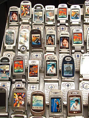 Various cell phones displayed at a shop.